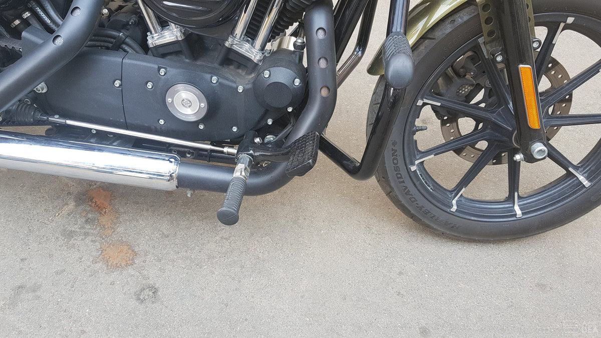 Side view of motorcycle forward foot controls mounted ahead of the engine