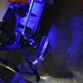 Close-up of blue lighting illuminating the motorcycle footboard area