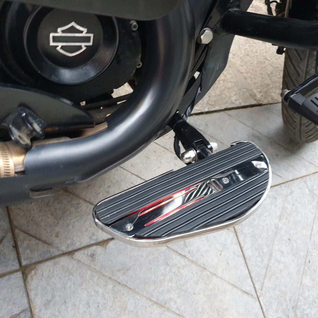 Close-up of motorcycle footboard with metallic side detailing