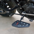 Forward control footboard fitted beside the motorcycle engine and frame