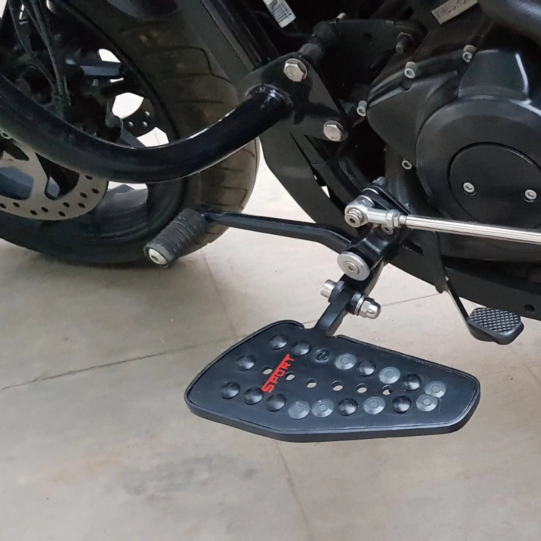 Forward control footboard fitted beside the motorcycle engine and frame