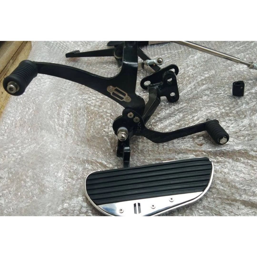 Side view of a motorcycle forward control footboard and its mounting bracket