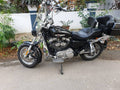 Touring motorcycle fitted with a front mudslinger near the front wheel