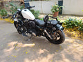 Side profile of a Harley-Davidson Sportster showing the fuel tank and overall motorcycle stance
