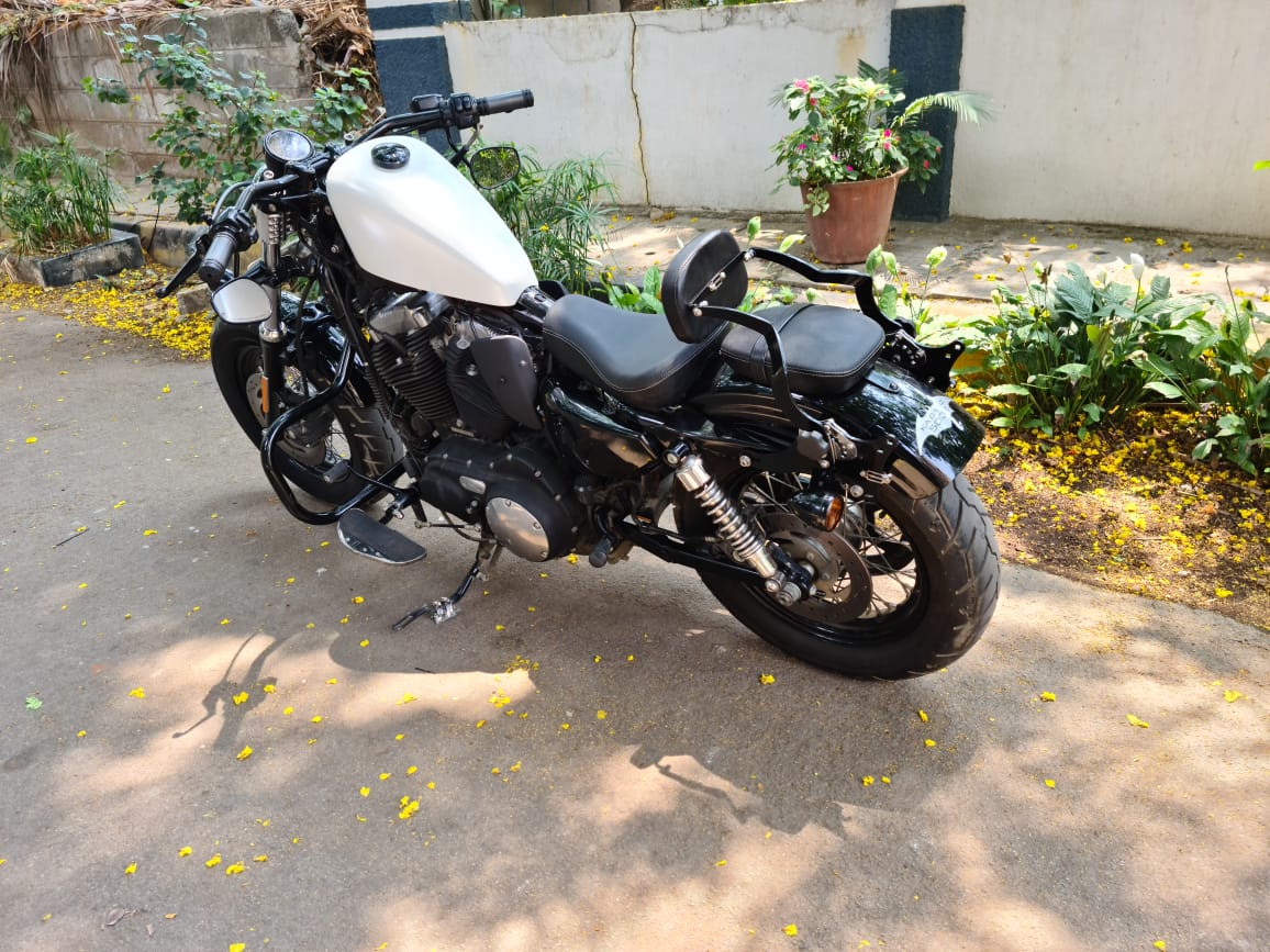 Side profile of a Harley-Davidson Sportster showing the fuel tank and overall motorcycle stance
