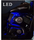 Pair of black motorcycle heat deflector shields illuminated by blue LED lighting