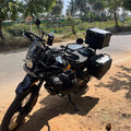 AeeDEA bottle holder mounted near the handlebar of Royal Enfield Himalayan 450 with touring luggage