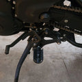Close-up of AeeDEA heel shifter mounting beside the stock mid-mount gear lever on Himalayan 450
