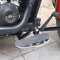Close-up of the installed forward control footboard beside the engine