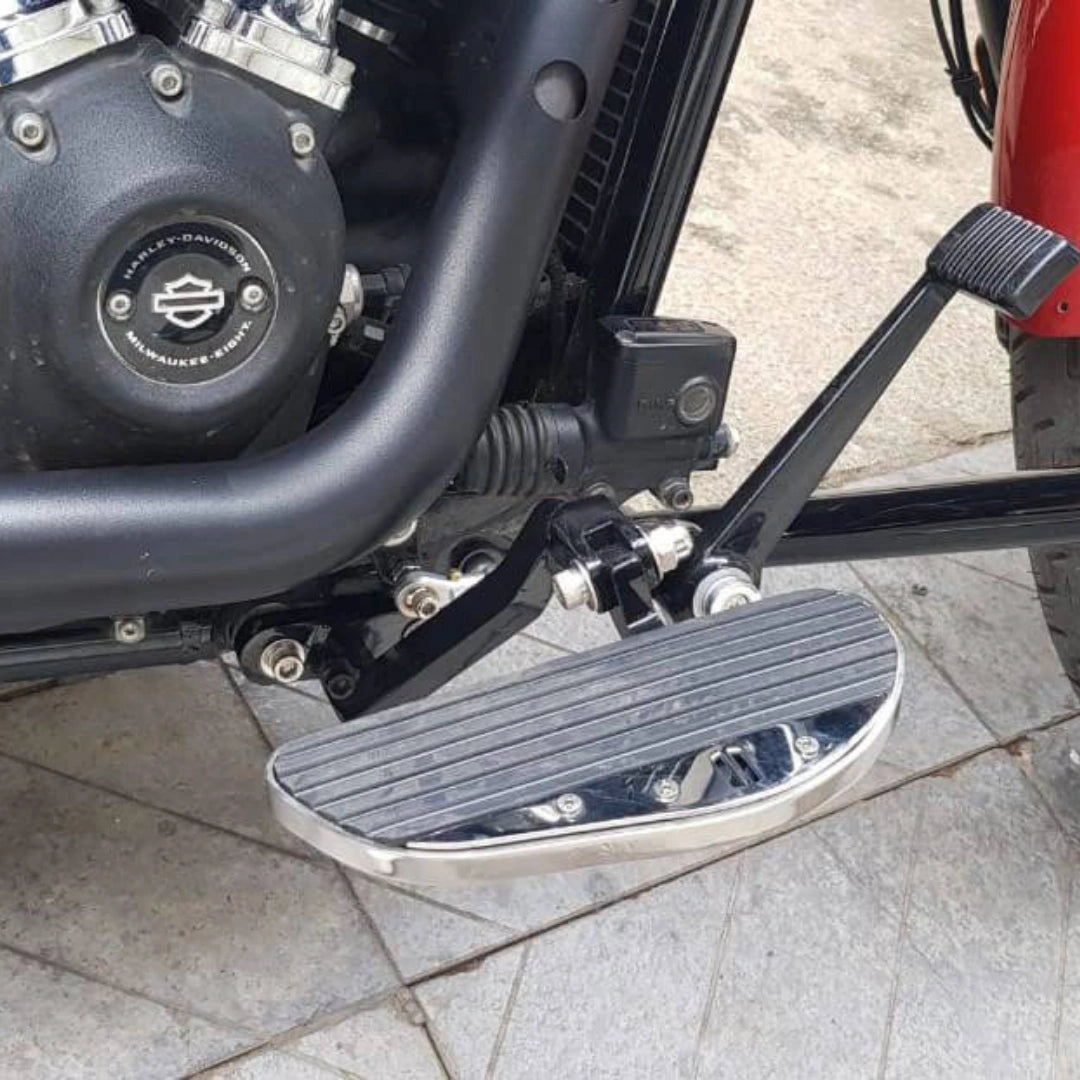 Close-up of the installed forward control footboard beside the engine