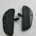 Close-up of the metal detailing and grip surface on a motorcycle footboard