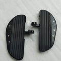 Top view of a pair of black motorcycle footboards showing their grip surfaces