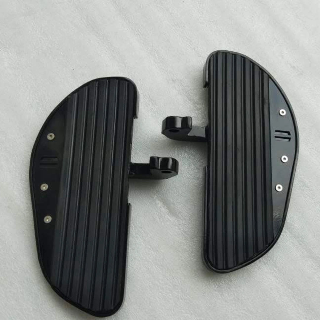 Top view of a pair of black motorcycle footboards showing their grip surfaces