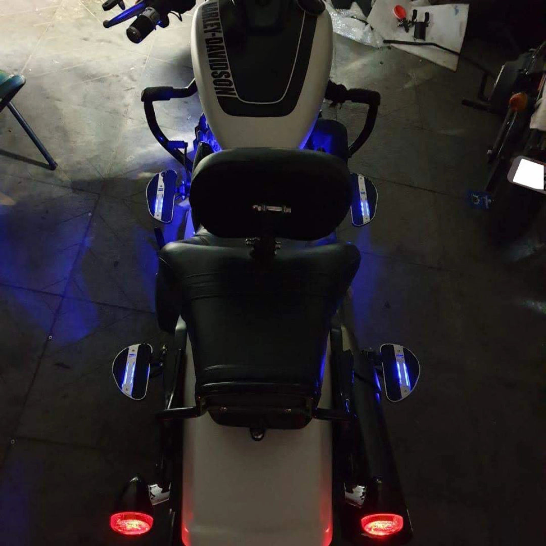 Motorcycle viewed from behind with blue illuminated passenger footboards