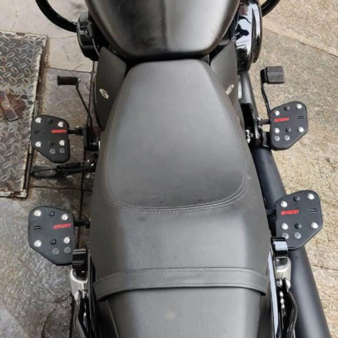 Motorcycle seat viewed from above with mid-mount rider footboards visible on both sides