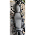 Top view of motorcycle seat and installed mid-mount rider footboards