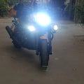 Motorcycle auxiliary light switched on, showing its bright front beam
