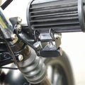 Close-up of an auxiliary light and its fork mounting arrangement
