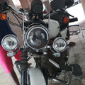 Motorcycle front lighting setup with auxiliary lights and mounting brackets