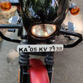 Close-up of motorcycle front number plate and surrounding front guard area