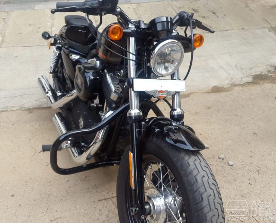 Top view of a black motorcycle fitted with tubular engine crash guards on both sides