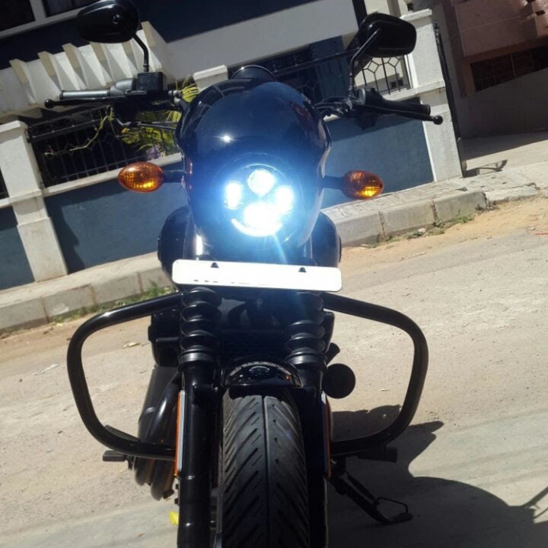 Front view of motorcycle showing the crash guard and illuminated headlight