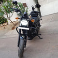 Front view of a black motorcycle with steel crash guard fitted around the engine