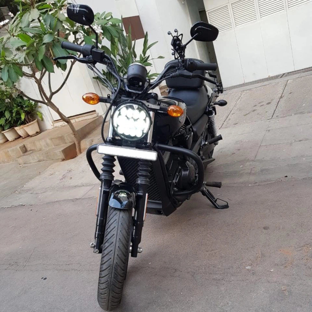 Front view of a black motorcycle with steel crash guard fitted around the engine
