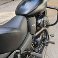 Black heat deflector mounted between the motorcycle seat and engine