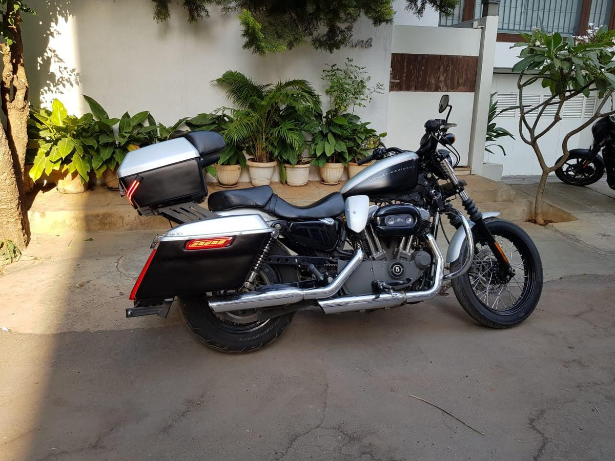 Side view of a motorcycle with heat deflectors installed beside the engine