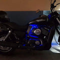 Blue LED lights illuminating the engine area around the fitted motorcycle heat deflector