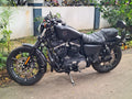 Black motorcycle with a front mudslinger mounted around the front wheel