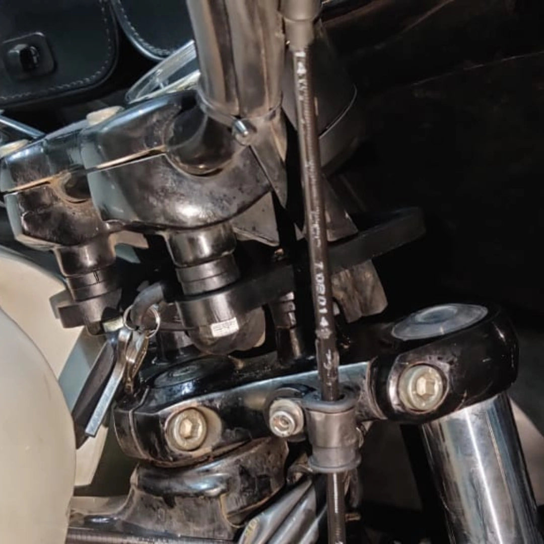 Close-up of AeeDEA handlebar reach extender mounting bracket installed on a motorcycle