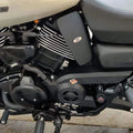 Side view of a motorcycle showing the black heat deflector fitted below the fuel tank