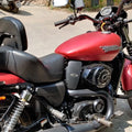 Close-up of a black heat deflector installed between the fuel tank and engine on a red motorcycle rear view