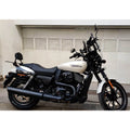 White motorcycle with black engine heat deflector fitted beside the engine