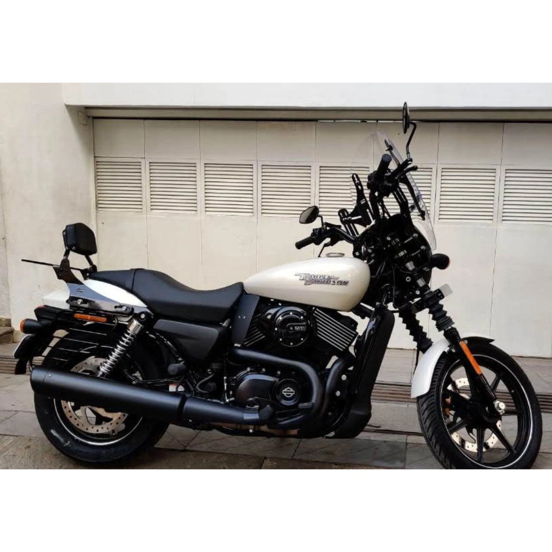 White motorcycle with black engine heat deflector fitted beside the engine