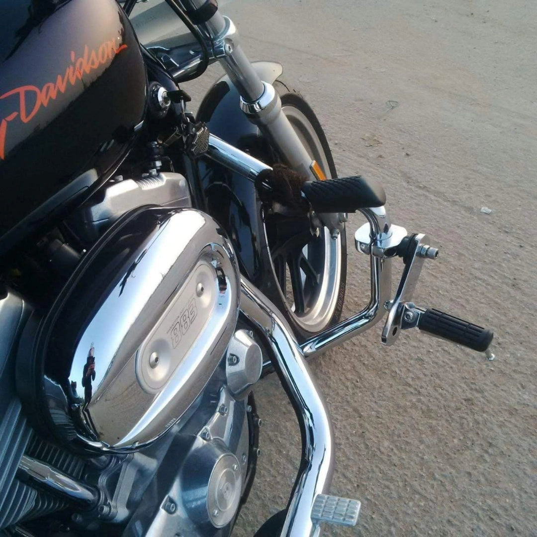 Close-up of a motorcycle highway footpeg extending outward from the engine guard