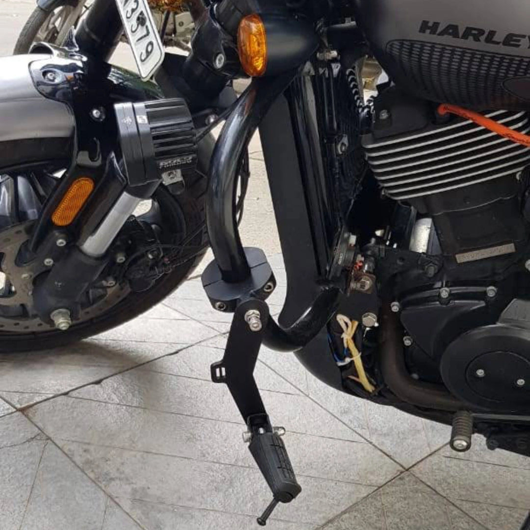 Black highway footpeg mounted beside the motorcycle engine
