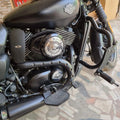 Close-up of adjustable highway footpegs fitted beside the motorcycle engine