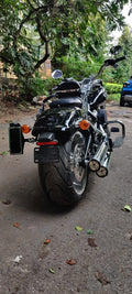 Rear view of a motorcycle with a side-mounted number plate