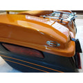 Close-up of an orange motorcycle touring pannier showing its exterior finish and trim