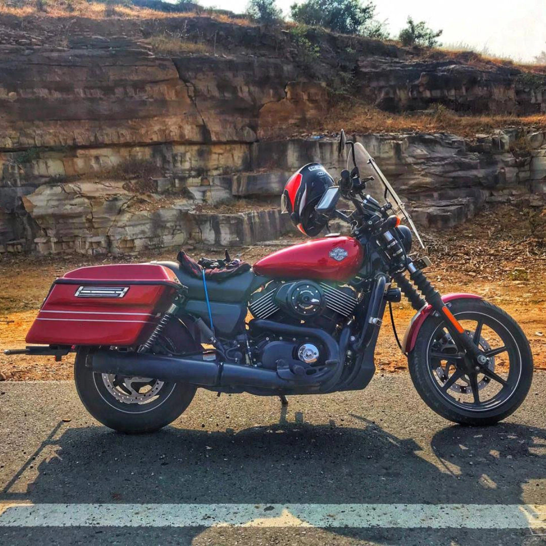 Red motorcycle with matching touring panniers installed on the rear sides