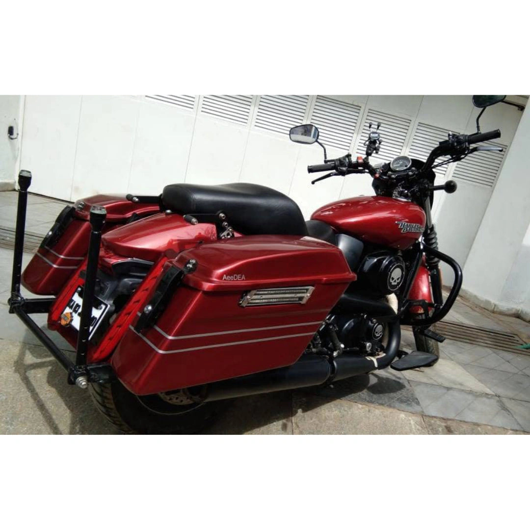Red motorcycle fitted with AeeDEA touring side panniers and black mounting carriage