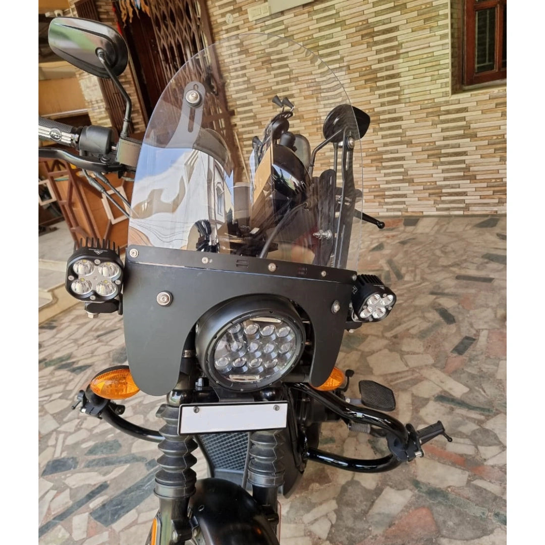 Front close-up of an adjustable windshield mounted above a motorcycle headlight