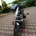 Motorcycle fitted with auxiliary lights on the front fork area
