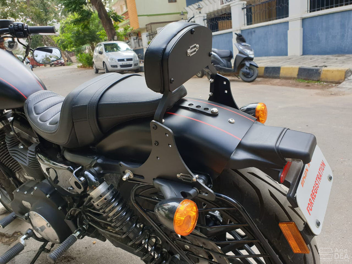 Moulded pillion backrest and mounting plates viewed from the rear side of a motorcycle