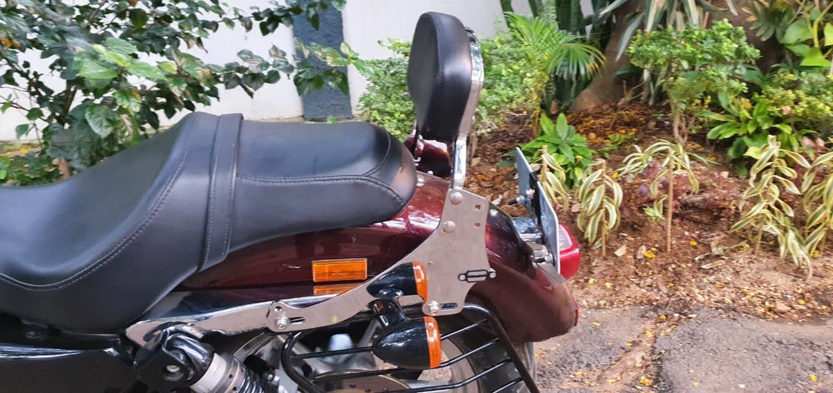 Tall pillion backrest installed on a red motorcycle, viewed from the side