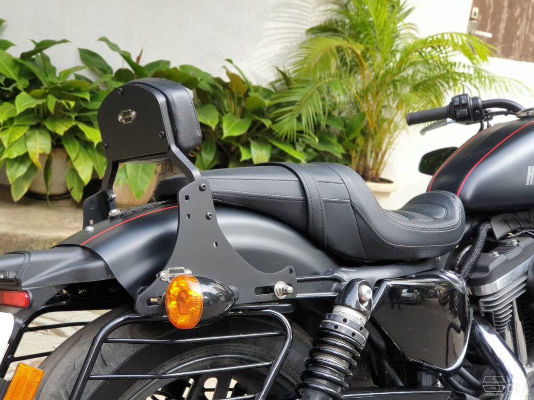 Moulded tall pillion backrest installed behind the seat of a black cruiser motorcycle