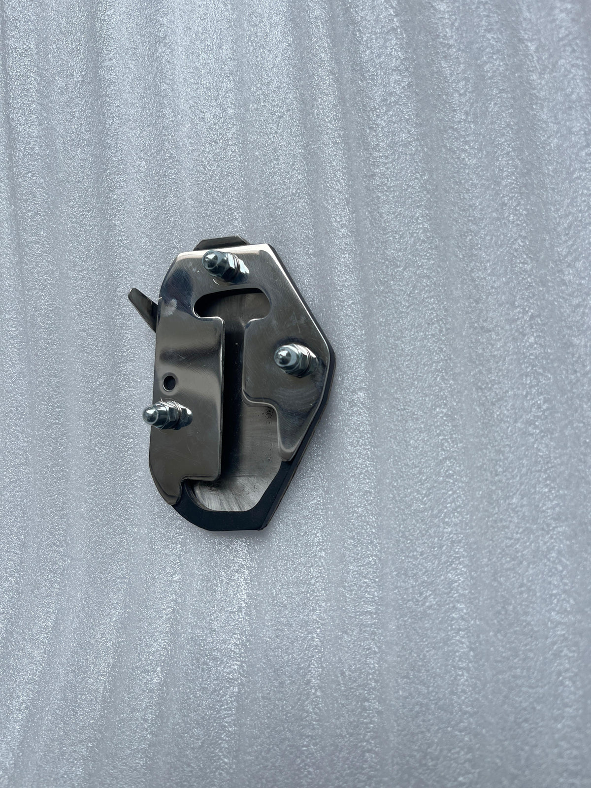 Front view of AeeDEA Pan America Stand Boot and its three mounting bolts